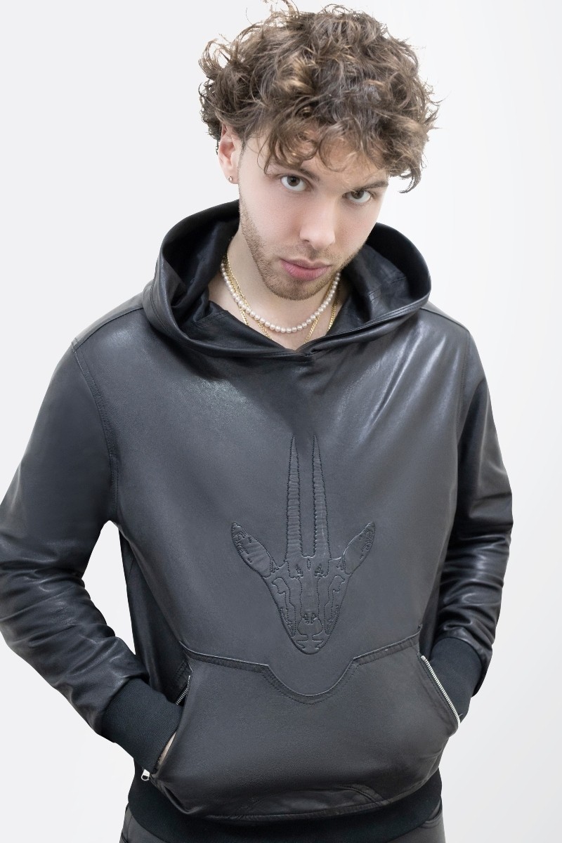 Model wearing a black leather hoodie with our gazelle logo imprint