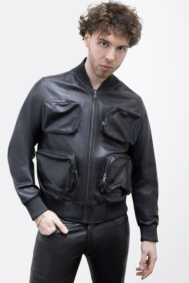 Male model wearing a leather bomber lined with square pockets.