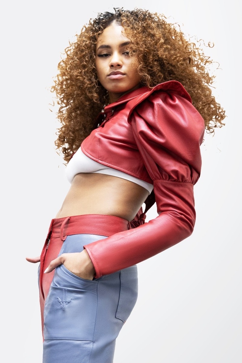 Female model wearing a red Tassel Cropped Leather Jacket: Premium leather jacket with tassel detailing, cropped length, and flattering fit.